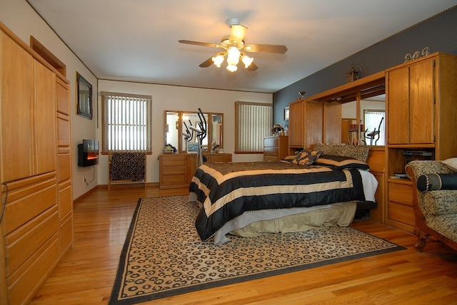 bedroom with ceiling fan and light hardwood / wood-style floors