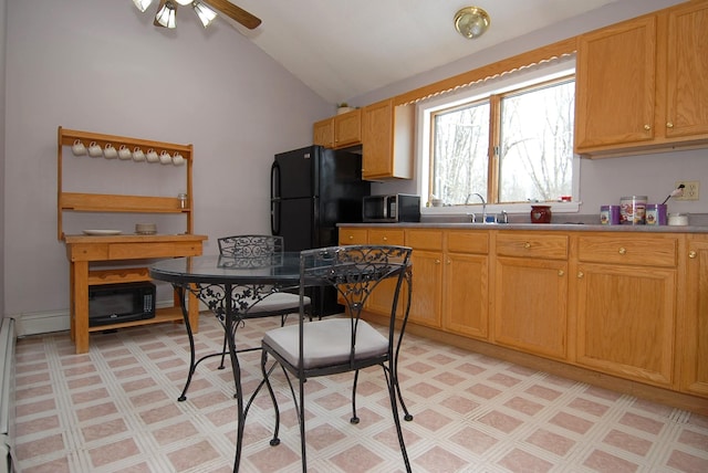 kitchen featuring ceiling fan, sink, vaulted ceiling, and black appliances