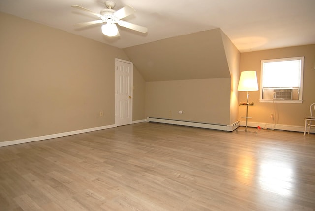 additional living space with lofted ceiling, light hardwood / wood-style flooring, ceiling fan, baseboard heating, and cooling unit