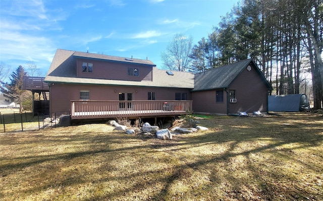 rear view of house with central air condition unit, a lawn, a deck, and fence