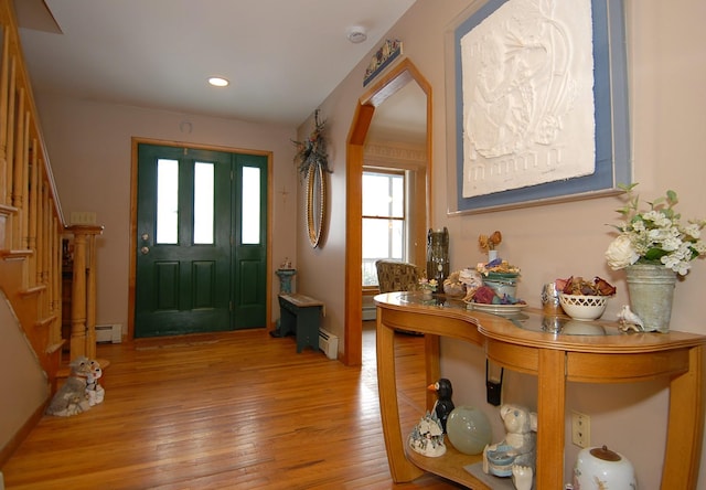 entrance foyer featuring recessed lighting, a baseboard heating unit, light wood-style flooring, and stairs