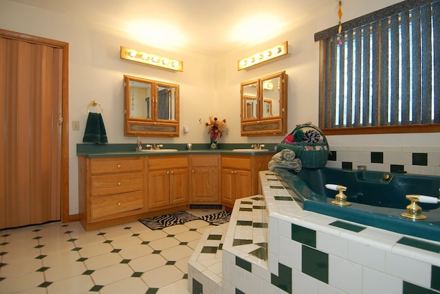 bathroom with a bath, tile patterned floors, and vanity
