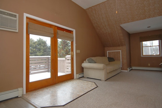 interior space featuring access to outside, a wall mounted air conditioner, lofted ceiling, and a baseboard radiator