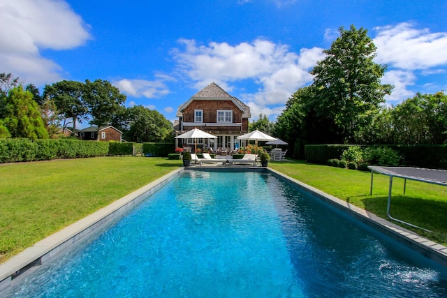 158 Norris Ln, Bridgehampton, NY 11932 - view of swimming pool featuring a patio, a trampoline, and a lawn