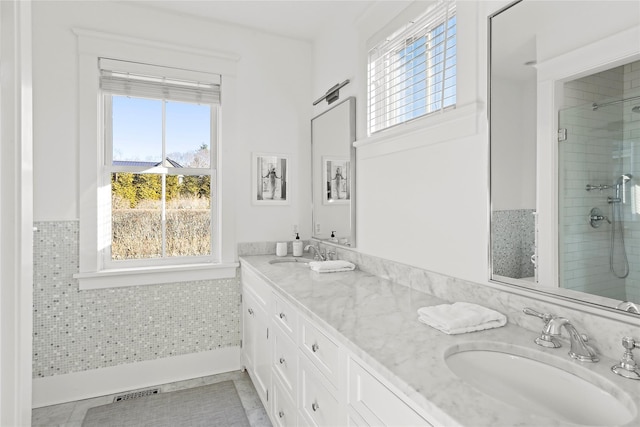 158 Norris Ln, Bridgehampton, NY 11932 - bathroom featuring vanity, a tile shower, and a wealth of natural light