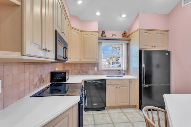 kitchen with sink, black appliances, tasteful backsplash, and light brown cabinets