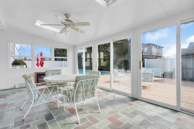 sunroom featuring ceiling fan and vaulted ceiling with skylight