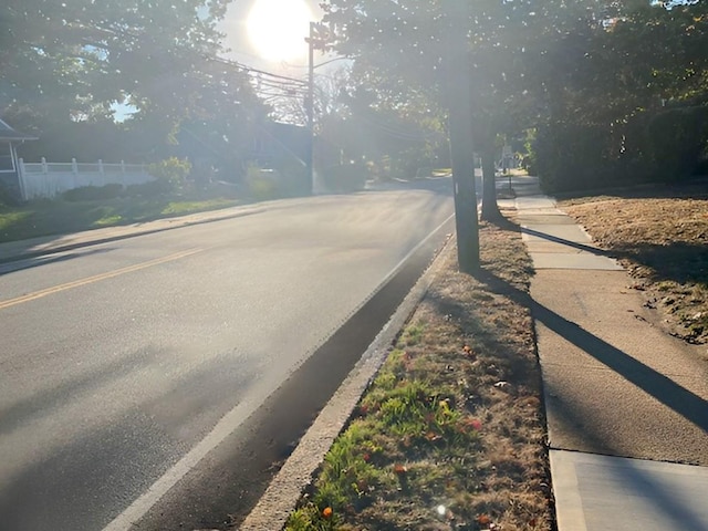 view of street with sidewalks and curbs