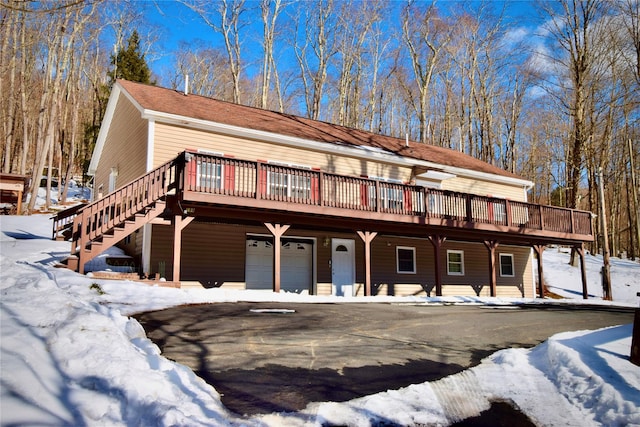 view of front facade featuring a wooden deck and a garage