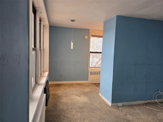 87-70 173rd St Unit 4N, Jamaica, NY 11432 - hallway featuring baseboards, carpet floors, and radiator