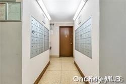87-70 173rd St Unit 4N, Jamaica, NY 11432 - corridor with light tile patterned flooring and baseboards