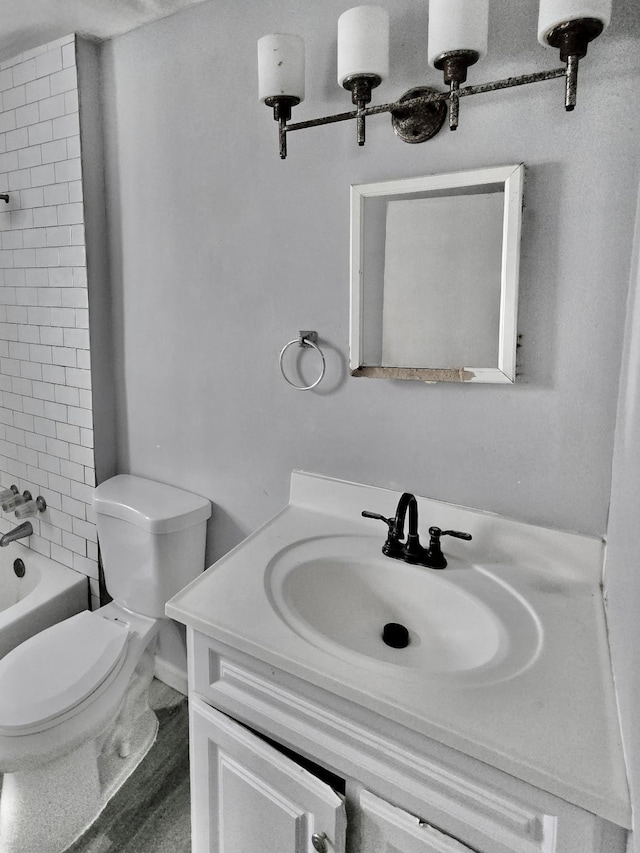 full bathroom with vanity, toilet, and tiled shower / bath combo