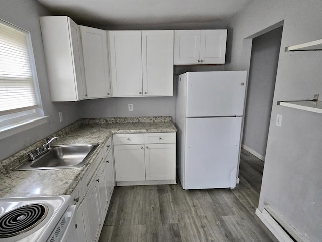 15 Harrison Unit 39E, Amityville, NY 11701 - kitchen with sink, white refrigerator, white cabinets, hardwood / wood-style flooring, and stove