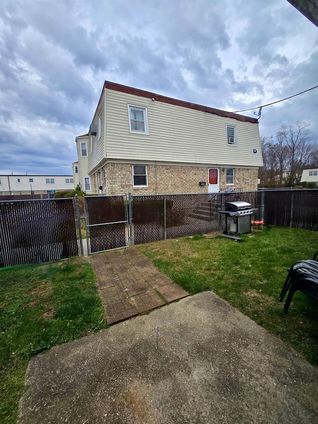 15 Harrison Unit 39E, Amityville, NY 11701 - back of house featuring a lawn