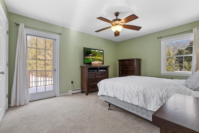 bedroom featuring multiple windows, access to outside, light colored carpet, and baseboard heating