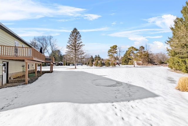 snowy yard with a wooden deck