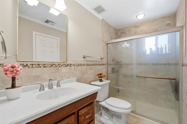 bathroom featuring toilet, tile walls, an enclosed shower, and vanity