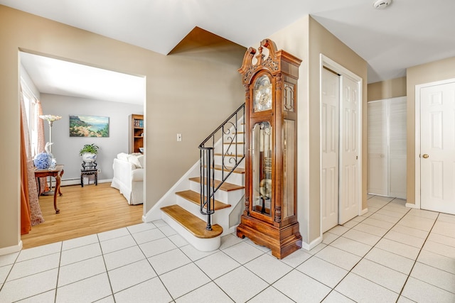 stairway featuring tile patterned flooring and baseboard heating