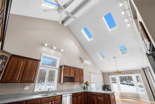 kitchen with a skylight, light countertops, an AC wall unit, a sink, and dishwasher