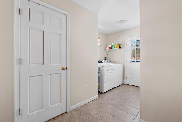 laundry room featuring laundry area, light tile patterned floors, baseboards, and separate washer and dryer