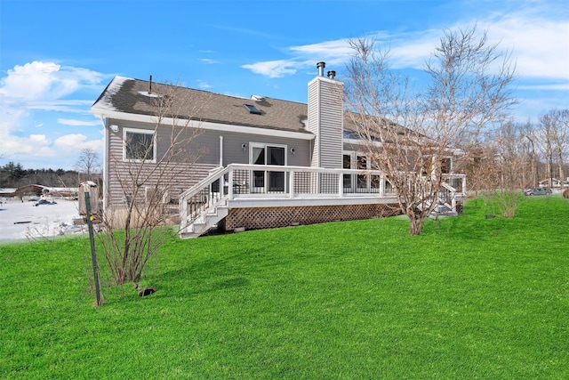 rear view of property with roof with shingles, a chimney, a deck, and a yard