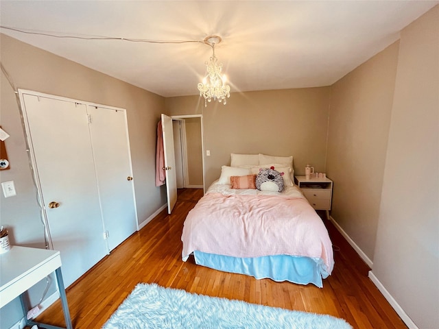 525 W 235th St Unit 5D, Bronx, NY 10463 - bedroom featuring wood finished floors, a chandelier, and baseboards