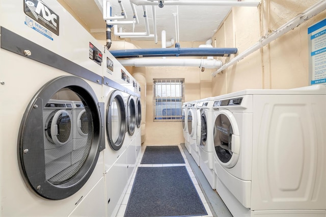 community laundry room with tile patterned floors and separate washer and dryer