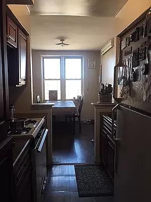 kitchen with black refrigerator, gas range, and dark hardwood / wood-style floors