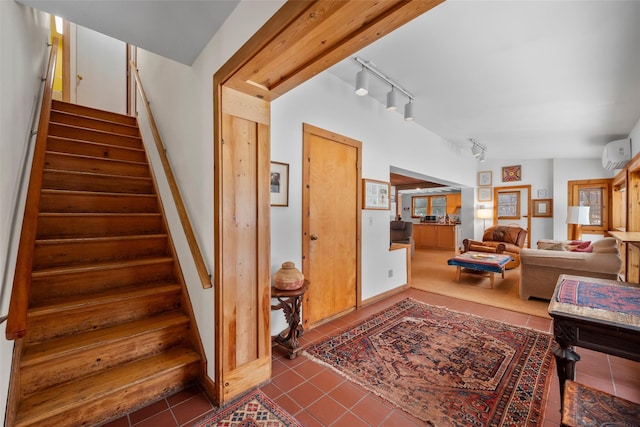 staircase featuring tile patterned flooring, track lighting, and a wall mounted AC