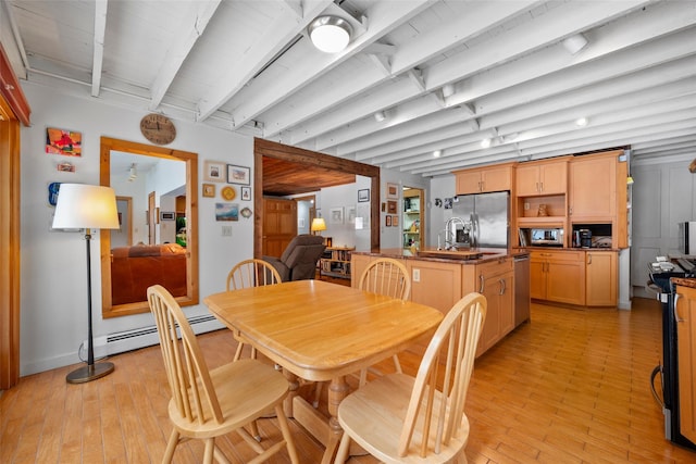 dining space featuring light wood-style floors and beamed ceiling