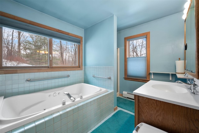 full bathroom featuring a jetted tub, baseboard heating, and vanity