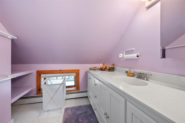 bathroom with vaulted ceiling, a baseboard radiator, vanity, and tile patterned floors