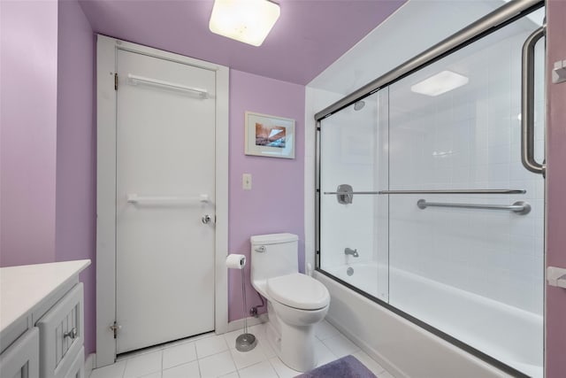 full bathroom with toilet, vanity, baseboards, combined bath / shower with glass door, and tile patterned floors