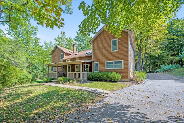 view of front of house with covered porch and a front yard