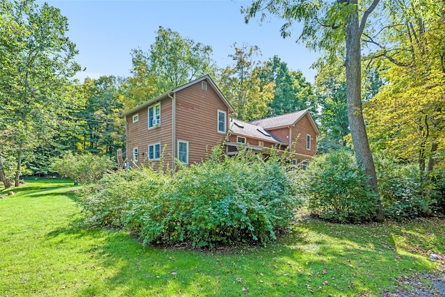 view of home's exterior with a lawn