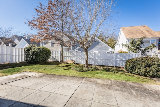 view of yard with a patio area, a residential view, and fence