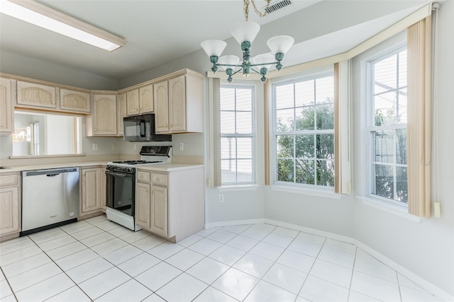 kitchen featuring black microwave, visible vents, light countertops, stainless steel dishwasher, and gas range