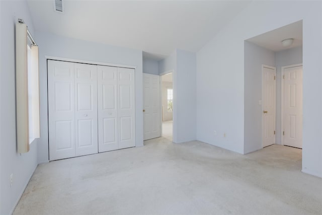 unfurnished bedroom featuring a closet, carpet flooring, and visible vents