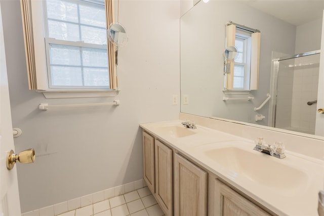 full bath with plenty of natural light, a sink, and tile patterned floors