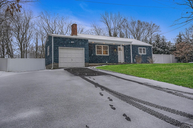 single story home featuring a garage and a front yard