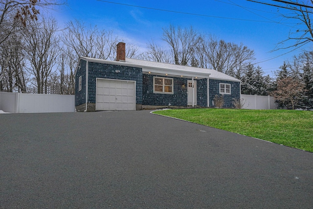 single story home featuring a garage and a front yard