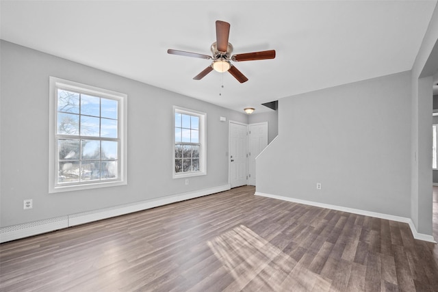 unfurnished living room featuring wood-type flooring, ceiling fan, and baseboard heating