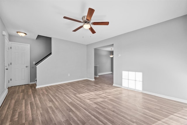 unfurnished living room with hardwood / wood-style flooring and ceiling fan