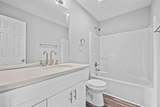 full bathroom with hardwood / wood-style flooring, toilet, vanity, and  shower combination