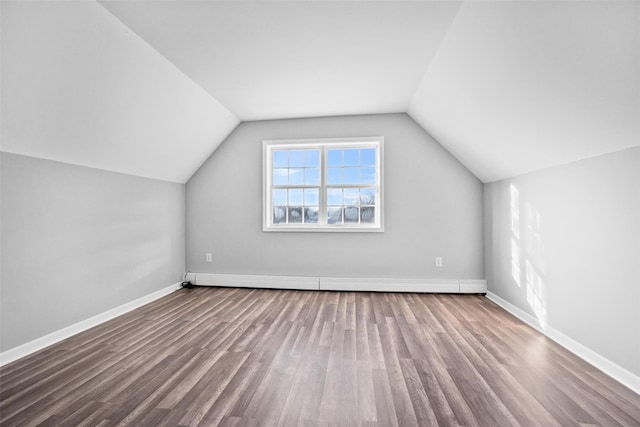 bonus room with vaulted ceiling, hardwood / wood-style floors, and baseboard heating