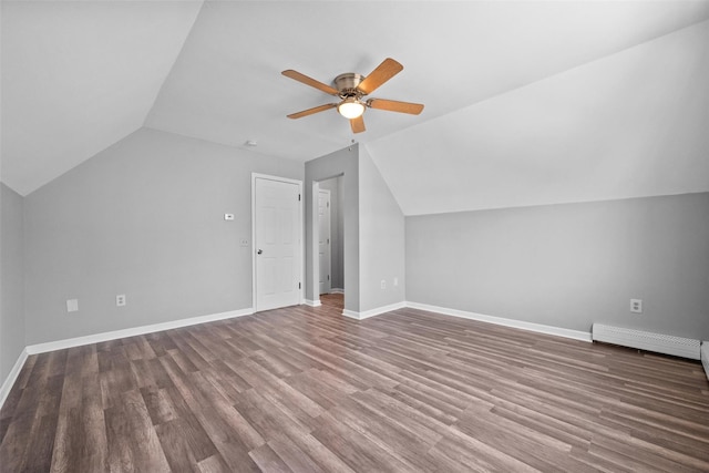 additional living space featuring wood-type flooring, lofted ceiling, a baseboard heating unit, and ceiling fan