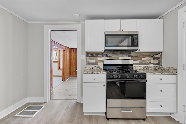 kitchen featuring light stone counters, white cabinetry, and appliances with stainless steel finishes