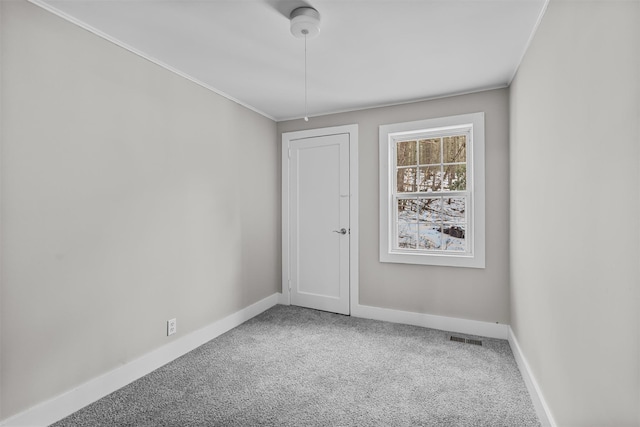 carpeted spare room with ornamental molding