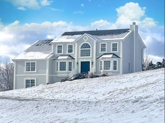 view of front of home featuring a chimney