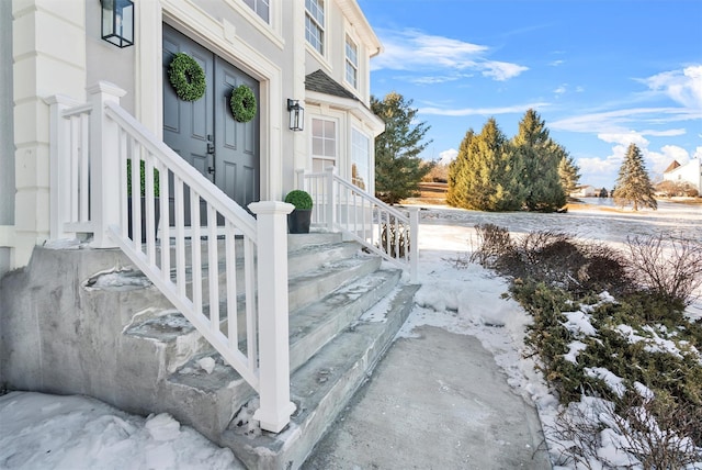 view of snow covered property entrance